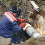 Technician repairing a Sewer line